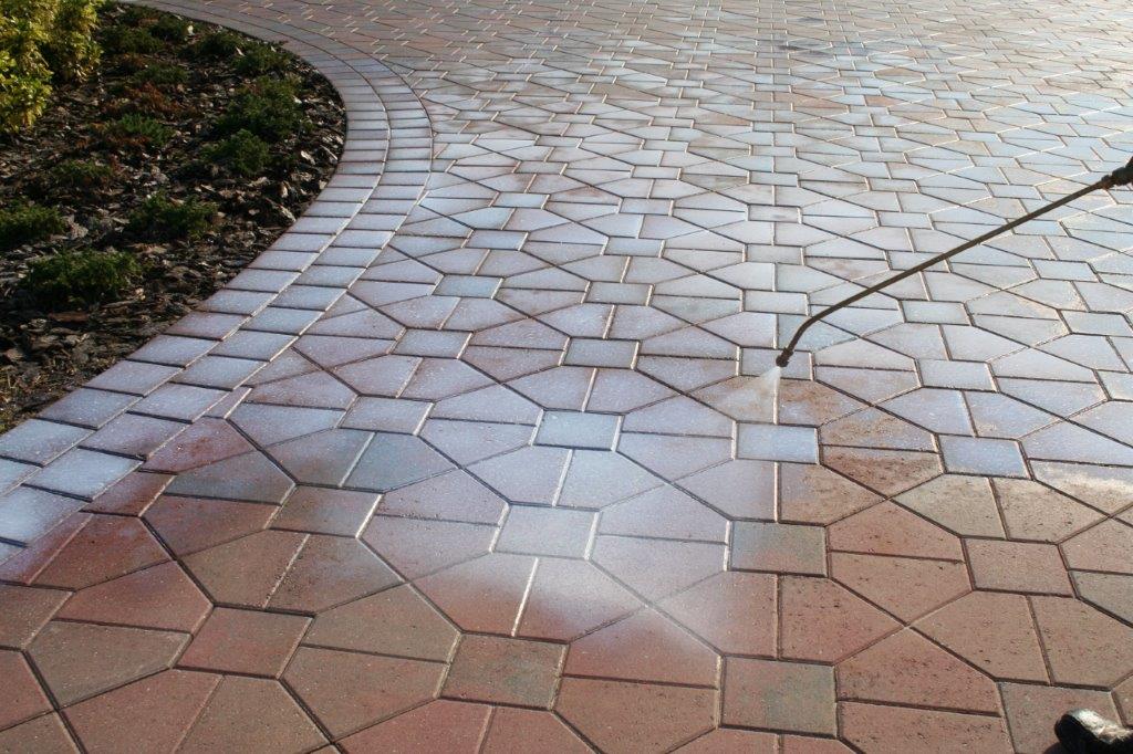 paver-sealer-being-sprayed-walkway